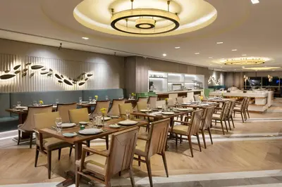 a restaurant with tables and chairs in a room at Titanic Port Bakirkoy in Istanbul