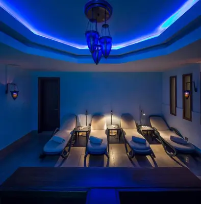 a therapy room with blue lights and chairs in it at Titanic Port Bakirkoy in Istanbul