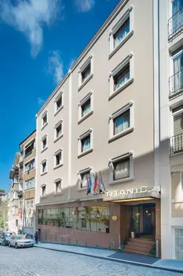 a large white building on a city street at Titanic Comfort Sisli in Istanbul