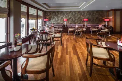 a dining room with wooden tables and chairs at Titanic Comfort Sisli in Istanbul