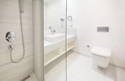 a white bathroom with a sink and a shower at Lina Hotel Taksim Pera in Istanbul
