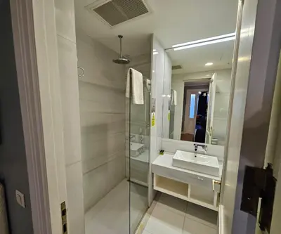 a bathroom with a sink and a mirror at Lina Hotel Taksim Pera in Istanbul