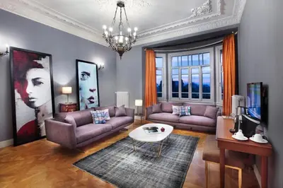 a living room with purple couches and a table at Lina Hotel Taksim Pera in Istanbul