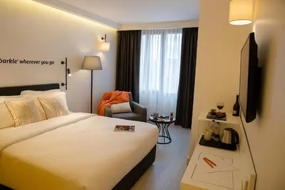 a hotel room with a bed and a chair at Sparkle Hotel in Istanbul