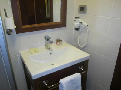 a bathroom with a sink and a shower at Hotel Perula & SPA in Istanbul