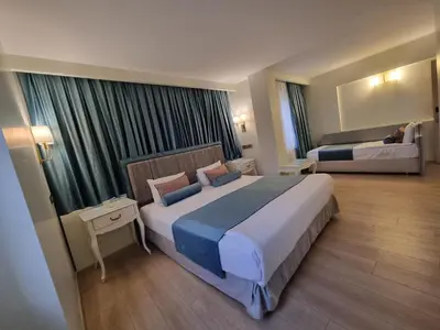 a hotel room with a large bed in a room at Taximtown Hotel in Istanbul