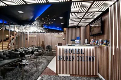 a lobby with couches and a sign that reads hotel broken columns at Hotel Broken Column in Istanbul