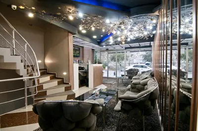 a living room with a staircase and couches at Hotel Broken Column in Istanbul