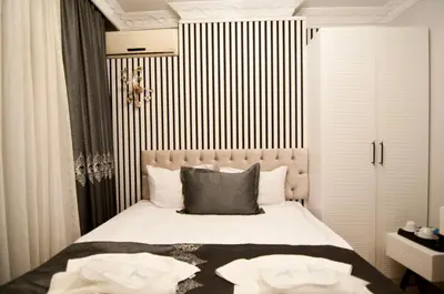 a bedroom with a bed with black and white stripes at Hotel Broken Column in Istanbul