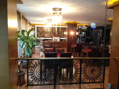 a dining room with chairs and a bar at Maya Hotel in Istanbul