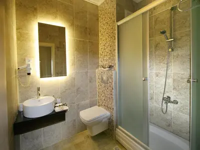 a bathroom with a toilet and a sink and a shower at Maya Hotel in Istanbul