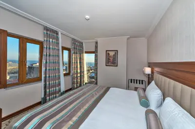 a hotel room with a bed and a window at Bekdas Hotel Deluxe & Spa in Istanbul