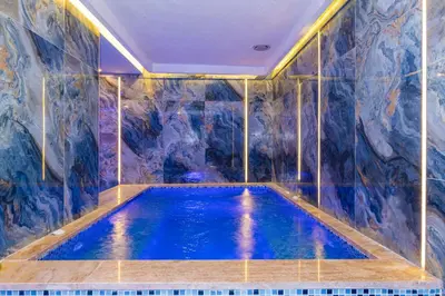 a indoor swimming pool in a room with a mural at Bekdas Hotel Deluxe & Spa in Istanbul