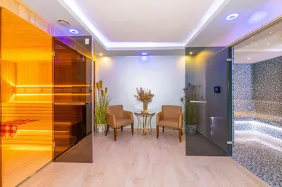 a bathroom with a shower and a table and chairs at Bekdas Hotel Deluxe & Spa in Istanbul