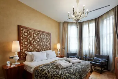 a hotel room with a bed and a chandelier at Taksim Prelude Hotel in Istanbul