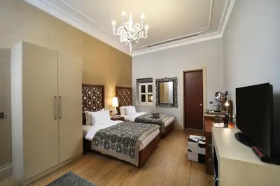 a hotel room with two beds and a television at The Story Hotel Pera in Istanbul