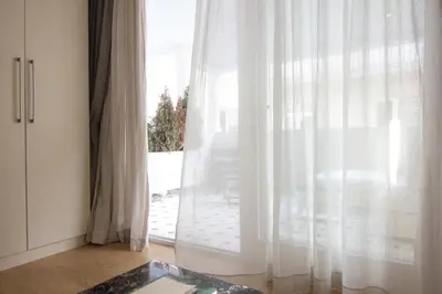a room with a large window with white curtains at The Story Hotel Pera in Istanbul