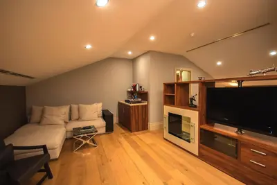 a living room with a couch and a flat screen tv at The Story Hotel Pera in Istanbul