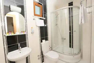 a bathroom with a shower and a toilet and a sink at Hotel Avcilar City in Avcılar
