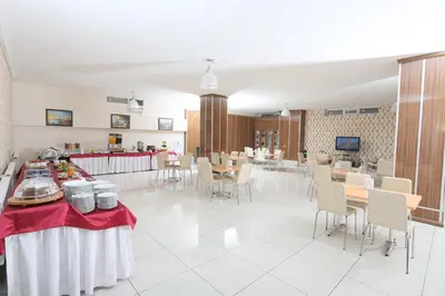 a dining room with tables and chairs and a cafeteria at Hotel Avcilar City in Avcılar