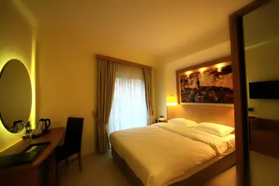 a bedroom with a bed and a desk and a window at Beyoglu MLS Hotel in Istanbul