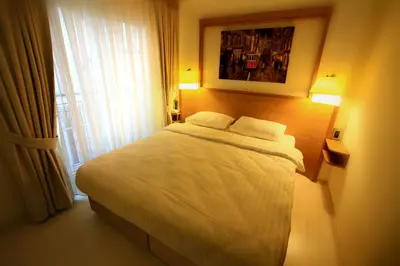 a bedroom with a white bed with a window at Beyoglu MLS Hotel in Istanbul