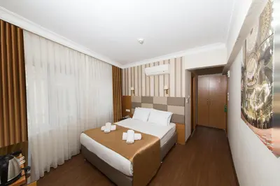 a bedroom with a bed with two candles on it at Aspalace Hotel The Istanbul Old City in Istanbul