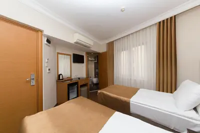 a hotel room with two beds and a television at Aspalace Hotel The Istanbul Old City in Istanbul