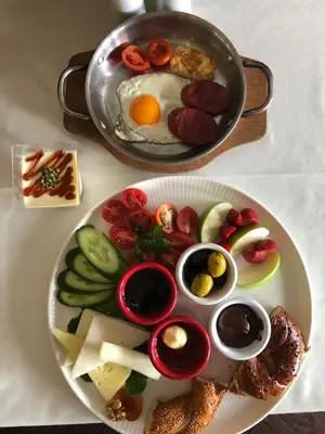 a plate of breakfast food with an egg on a table at Meroddi Pera Flats in Istanbul