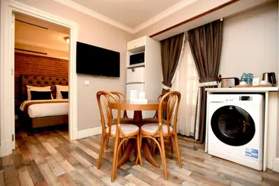 a room with a table and a washing machine at Meroddi Pera Flats in Istanbul