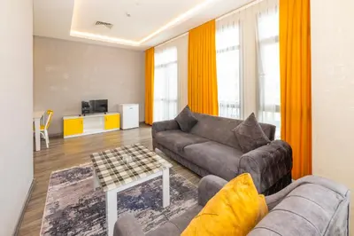 a living room with a couch and a table at Agora Suites in Esenyurt