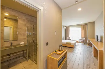 a hotel room with a bed and a bathroom at Agora Suites in Esenyurt