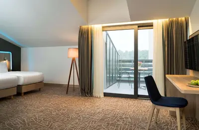a hotel room with a bed and a balcony at Park Inn by Radisson Istanbul Airport Odayeri in Istanbul