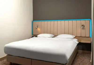 a bedroom with a large bed with white sheets at Park Inn by Radisson Istanbul Airport Odayeri in Istanbul