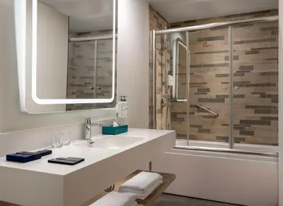a white bathroom with a sink and a shower at Park Inn by Radisson Istanbul Airport Odayeri in Istanbul