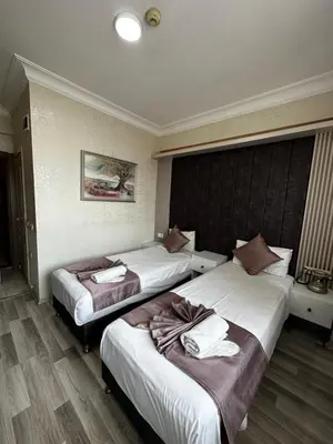 a hotel room with two beds with towels on them at Divas Silver in Istanbul