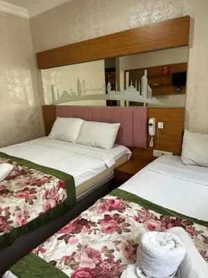 two beds in a hotel room with flowers on them at Divas Silver in Istanbul