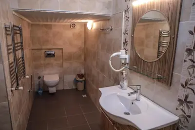 a bathroom with a sink and a mirror and a toilet at Aslan Home Apart in Istanbul