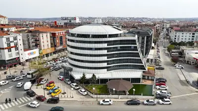 a large building in a city with a parking lot at Golden Palas Hotel in Cerkezkoy