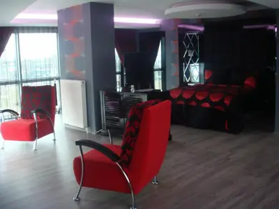 a room with a bed and two red chairs at Golden Palas Hotel in Cerkezkoy