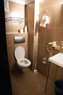 a small bathroom with a toilet and a sink at Pearl Hotel İstanbul in Istanbul
