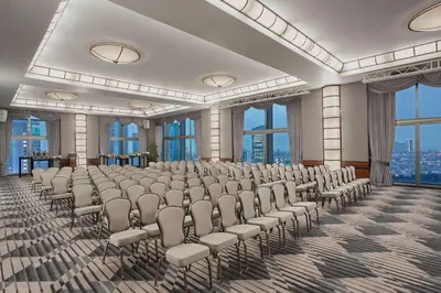 a room with rows of chairs in a room with windows at Hyatt Centric Levent Istanbul in Istanbul