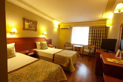 a hotel room with two beds and a television at Boyuguzel Termal Hotel in Bursa