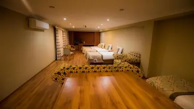 a hotel room with two beds and a couch at Boyuguzel Termal Hotel in Bursa