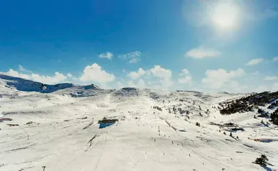 a snow covered mountain with the sun in the sky at Kaya Uludag in Uludag