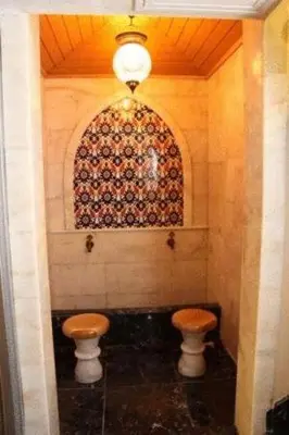 a bathroom with two stools and a wall with a window at Dareyn Hotel in Istanbul