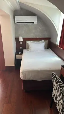 a bedroom with a large bed with a window at Dareyn Hotel in Istanbul