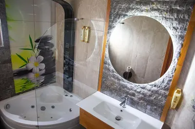 a bathroom with a tub and a sink and a mirror at Emirtimes Hotel Kadıköy in Istanbul