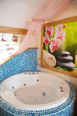 a bath tub in a room with a painting at Emirtimes Hotel Kadıköy in Istanbul