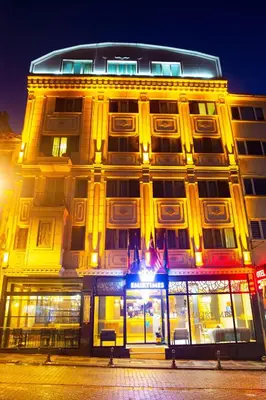 a large building with yellow lights on the side of it at Emirtimes Hotel Kadıköy in Istanbul
